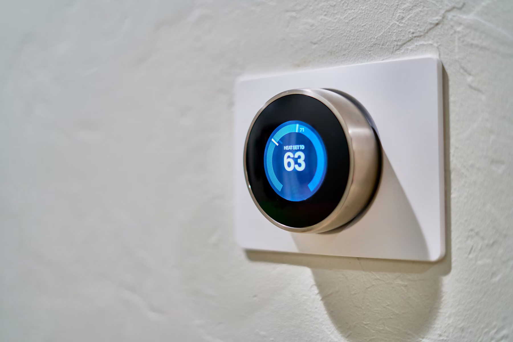 Smart thermostat mounted on a wall